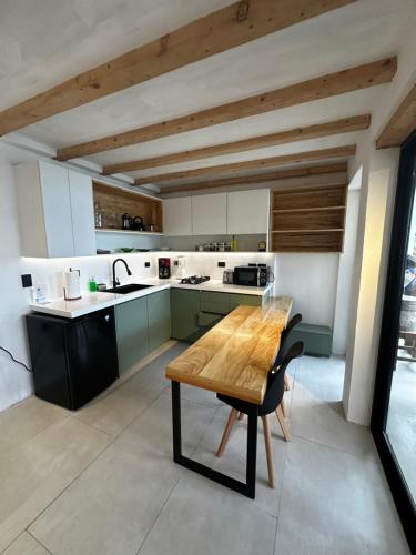a kitchen with a wooden table in the middle at Atitlan Sunset Lodge in Santa Cruz La Laguna