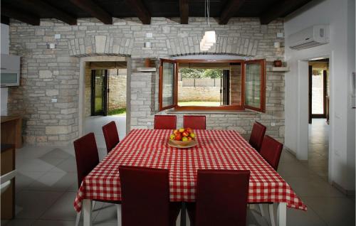 a dining room with a table with a bowl of fruit on it at Villa Grandparents in Rovinj