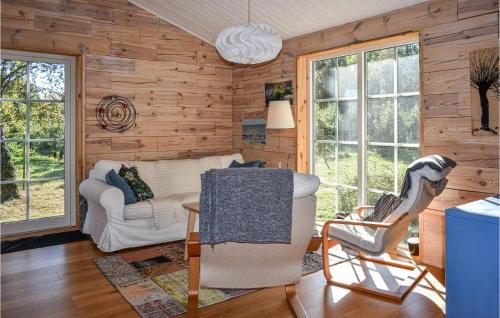 a living room with a couch and two chairs at Lovely Home In Simrishamn With Kitchen in Simrishamn