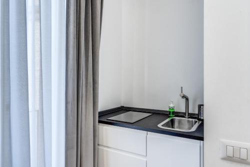 a kitchen with a sink and a shower curtain at Suite della Pigna in Rome