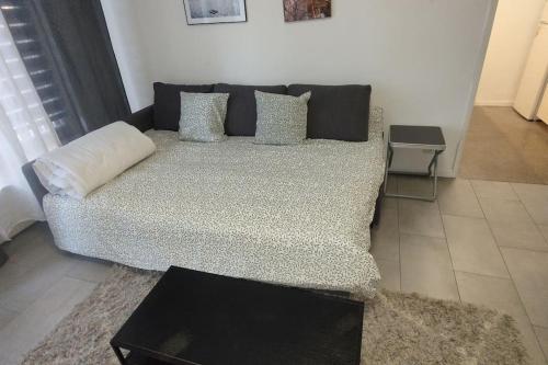 a couch with pillows in a living room at Pleasant apartment ready for you to enjoy in Antwerp