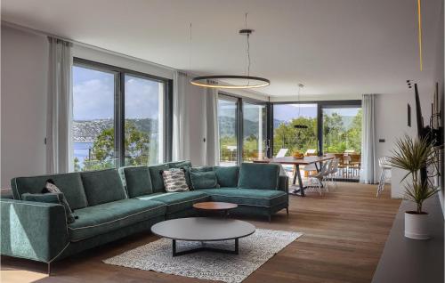 a living room with a green couch and a table at Villa Adria Blue in Bakarac
