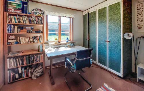 a desk with a chair in a room with a window at Nice Home In Osby With Wifi in Osby