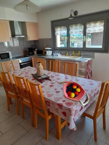 une cuisine avec une table avec un bol de fruits dessus dans l'établissement Appart 4 chambres - Centre Lélex, à Lélex
