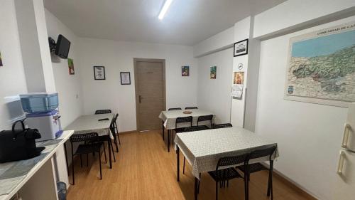 a room with tables and chairs in a room at Rural El Bosque in Entrambasaguas