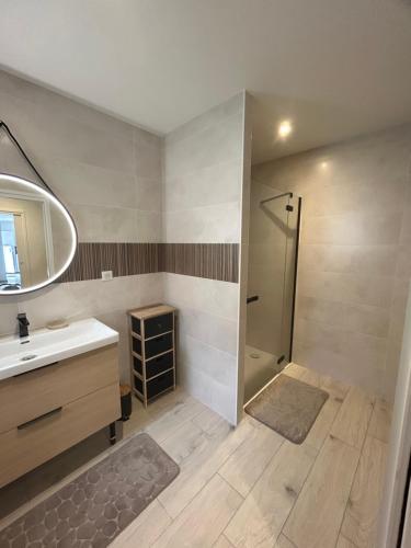 a bathroom with a sink and a shower at maison rue neuve in Plouay