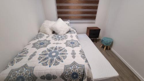 une chambre avec un lit avec une couette dessus dans l'établissement Apartamento a pasos del Mar, à La Serena