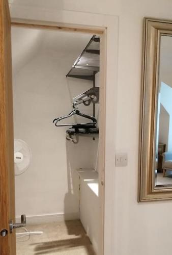 a mirror in a hallway next to a room at The Highlands - 5 bed 5 bath - Huge Sociable House in Exning