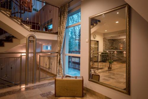 a suitcase is sitting in a hallway with a window at Pensjonat Adria in Zakopane