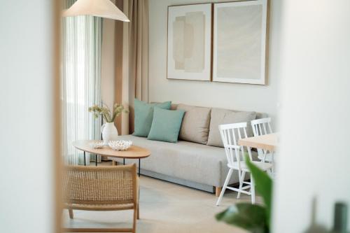 a living room with a couch and a table at Magnolia Villas Potos Thassos in Potos