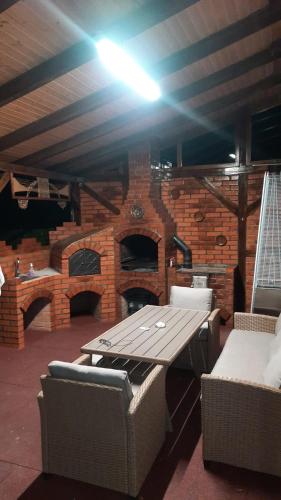 a picnic table in front of a brick oven at Izvorul Maleii in Petrila