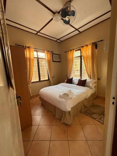 a bedroom with a bed and a window at Mibuyu Miwili in Morogoro