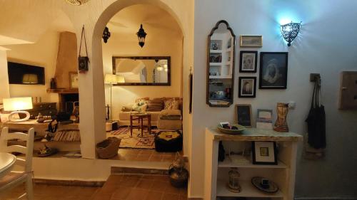 a living room with an archway and a living room with a couch at DAR MOUIMA in Tangier