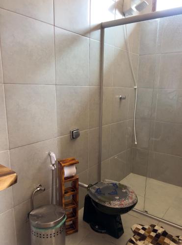 a bathroom with a shower and a toilet in it at Chale com vista e acesso ao Rio Grande - MG in Delfinópolis