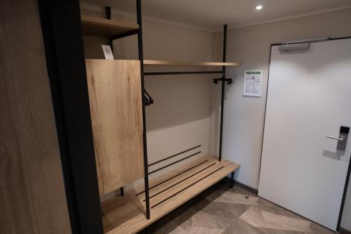 a closet with a glass door next to a stall at Olymp Munich in Eching