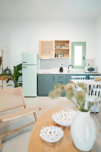 a kitchen with a table with two plates on it at Magnolia Villas Potos Thassos in Potos