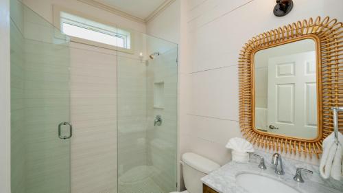 a bathroom with a shower and a sink and a mirror at Mermaid Magic by Last Key Realty in Cudjoe Key