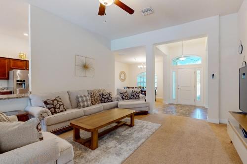 a living room with a couch and a table at Royal Highlands Tranquility in Spring Hill