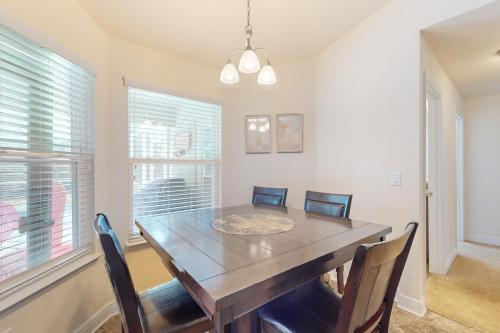 a dining room with a wooden table and chairs at Royal Highlands Tranquility in Spring Hill