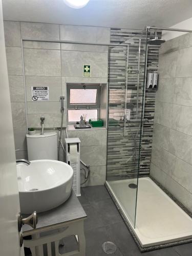 a bathroom with a sink and a shower and a tub at Casa da Ti Cristina in Pomares