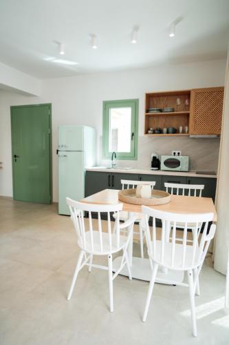 a kitchen with a table and two chairs and a table at Magnolia Villas Potos Thassos in Potos