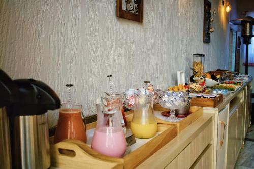 a counter with a bunch of different colored vases at Pousada Geada de Campos in Campos do Jordão