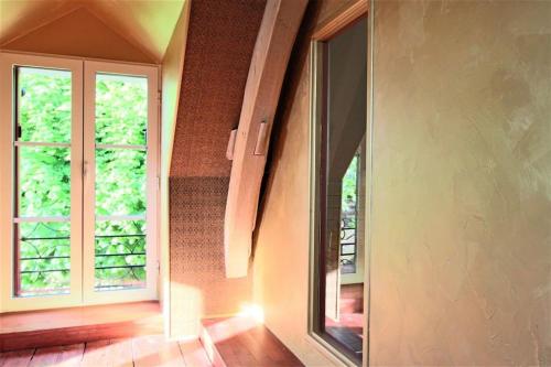 an empty room with a window and a staircase at Maison ancienne moderne et design - 6 chambres 6 sdb - avec piscine et grand parc in Buxeuil