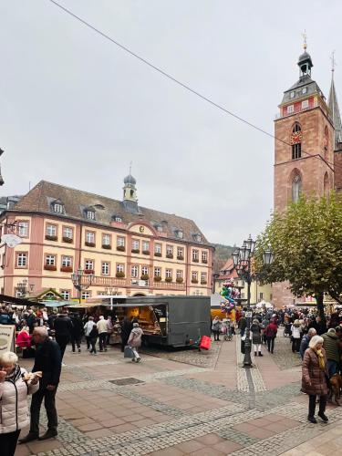 a group of people walking around a city with a bus at ARTvacanza Neustadt in Neustadt an der Weinstraße
