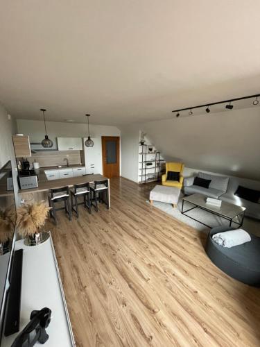 a living room with a dining room and a kitchen at Apartmán D3 in Veľká Lomnica