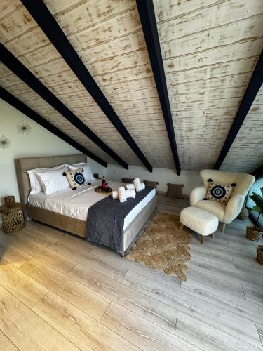 a bedroom with a bed and a chair at Sofita La Vita in Preveza