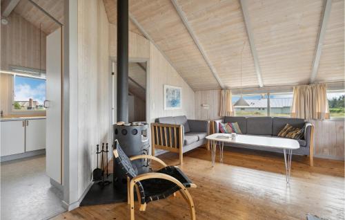 a living room with a couch and a table at Holiday Home Vesterledvej Xi in Havrvig