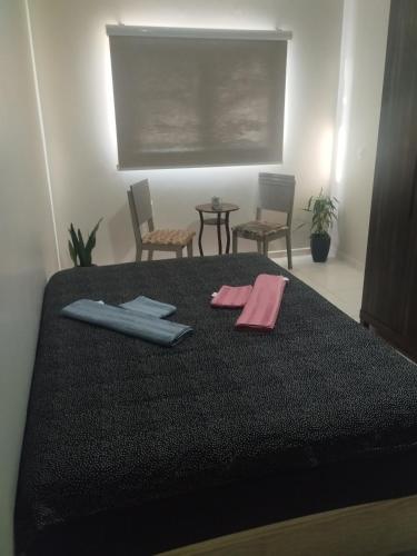Ένα ή περισσότερα κρεβάτια σε δωμάτιο στο Residencial Alves