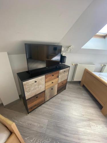 a dresser with a flat screen tv on top of it at Pension Lizzi in Vienna