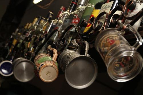 a bunch of pots and pans hanging on a wall at Casa Bradet in Întorsura Buzăului