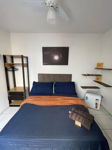 a bedroom with a bed with a tv on the wall at Casa Estelar in Cabo Frio