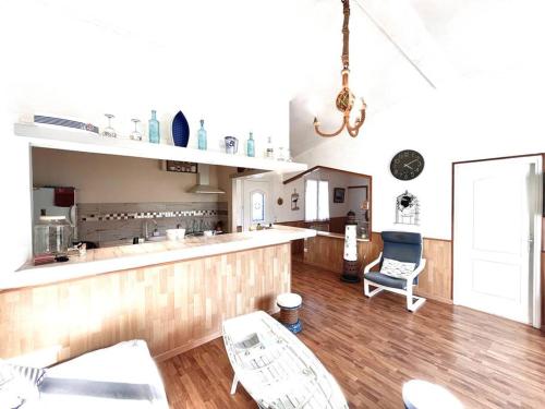 - une cuisine avec un comptoir et des chaises dans la chambre dans l'établissement Maison Marina Pietra avec Jardin, à Pietracorbara