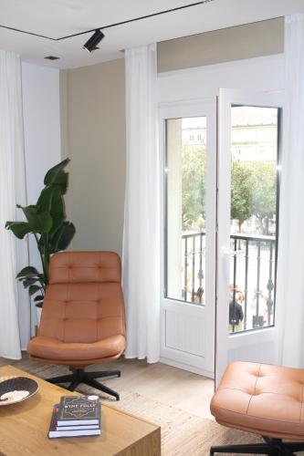 a living room with a chair and a table at Apartamentos La Herradura Toneles in Haro