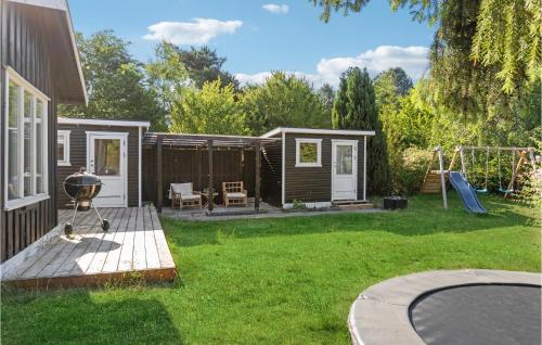 a backyard with a cabin and a playground at Stunning Home In Nykøbing Sj With Wifi in Nykøbing Sjælland