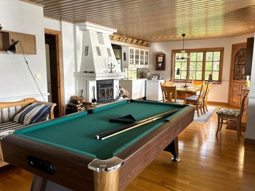 a pool table in a living room with a fireplace at 4 star holiday home in Åmål in Åmål