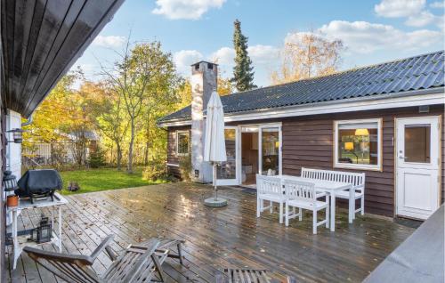 a patio with a table and chairs and an umbrella at Amazing Home In Nykøbing Sj With Wifi in Nykøbing Sjælland