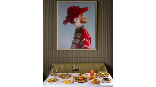 a table with plates of food on top of it at art'otel London Battersea Power Station, Powered by Radisson Hotels in London