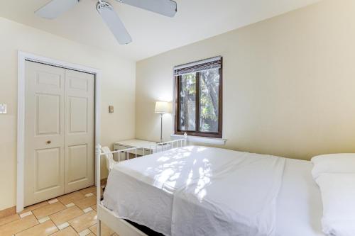 a white bedroom with a bed and a window at Spacious King of Prussia Home with 2 Game Rooms in King of Prussia