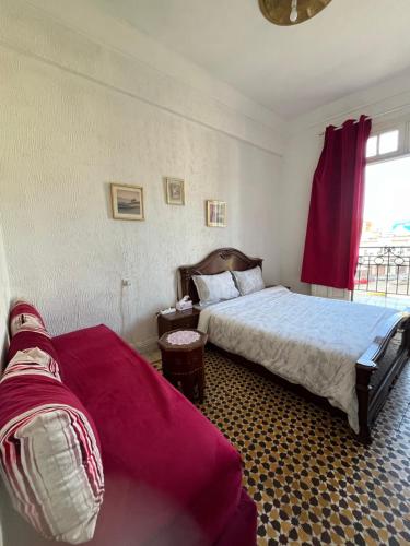 a bedroom with two beds and a window at Chez Mia in Fès