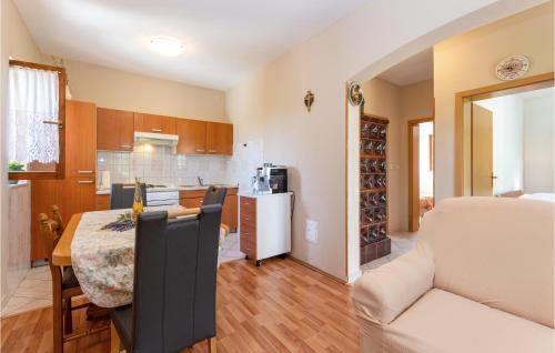 a kitchen and dining room with a table and chairs at 2 Bedroom Amazing Home In Pridraga in Pridraga