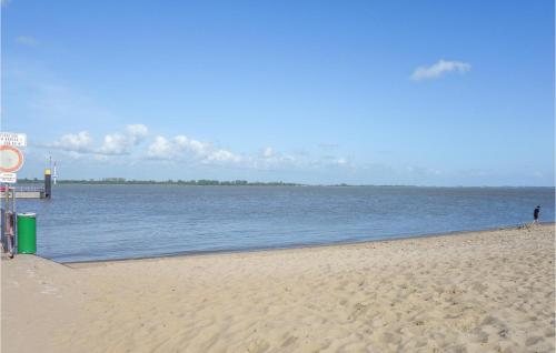 a sandy beach next to a body of water at Nice Home In Drochtersen in Drochtersen