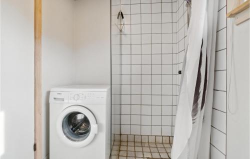a white washer and dryer in a bathroom at 2 Bedroom Nice Home In Gudhjem in Rø