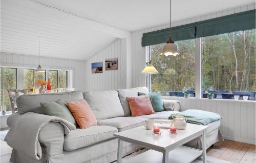 a living room with a couch and a table at Holiday Home Gubbegårdsvejen Nexø Vi in Bedegård