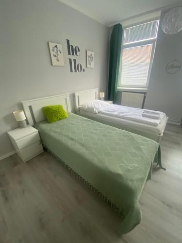 a bedroom with a large bed and a window at Pension Lizzi in Vienna