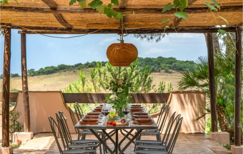 a wooden table with chairs and a table with food on it at Villa Monte Bottigli in Grosseto