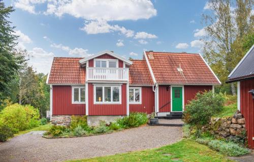 a red house with a red roof at 3 Bedroom Nice Home In Tving in Tving
